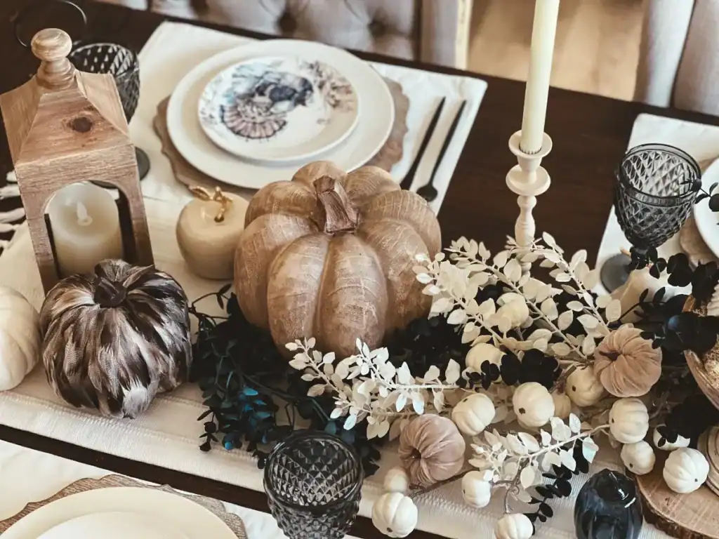 A Blue and White Thanksgiving tablescape decorated with wood pumpkins and blue and white accents