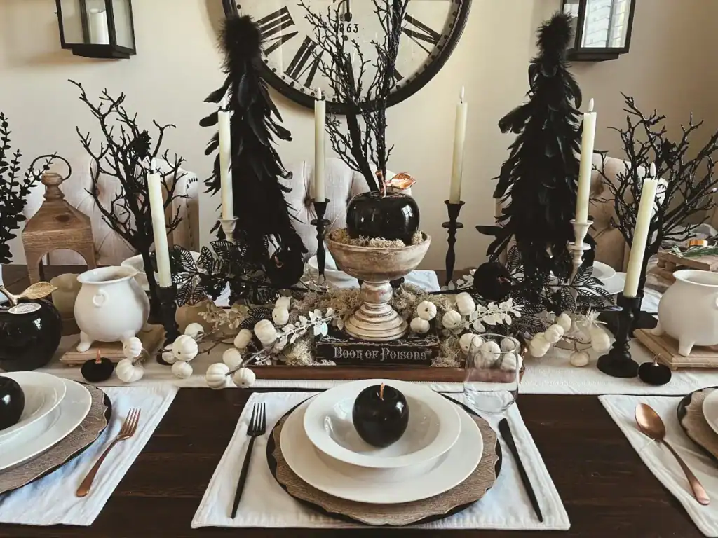 An entire Halloween Tablesccape with all black and white decorations for six people including black poisoned apples and classy white and black decor