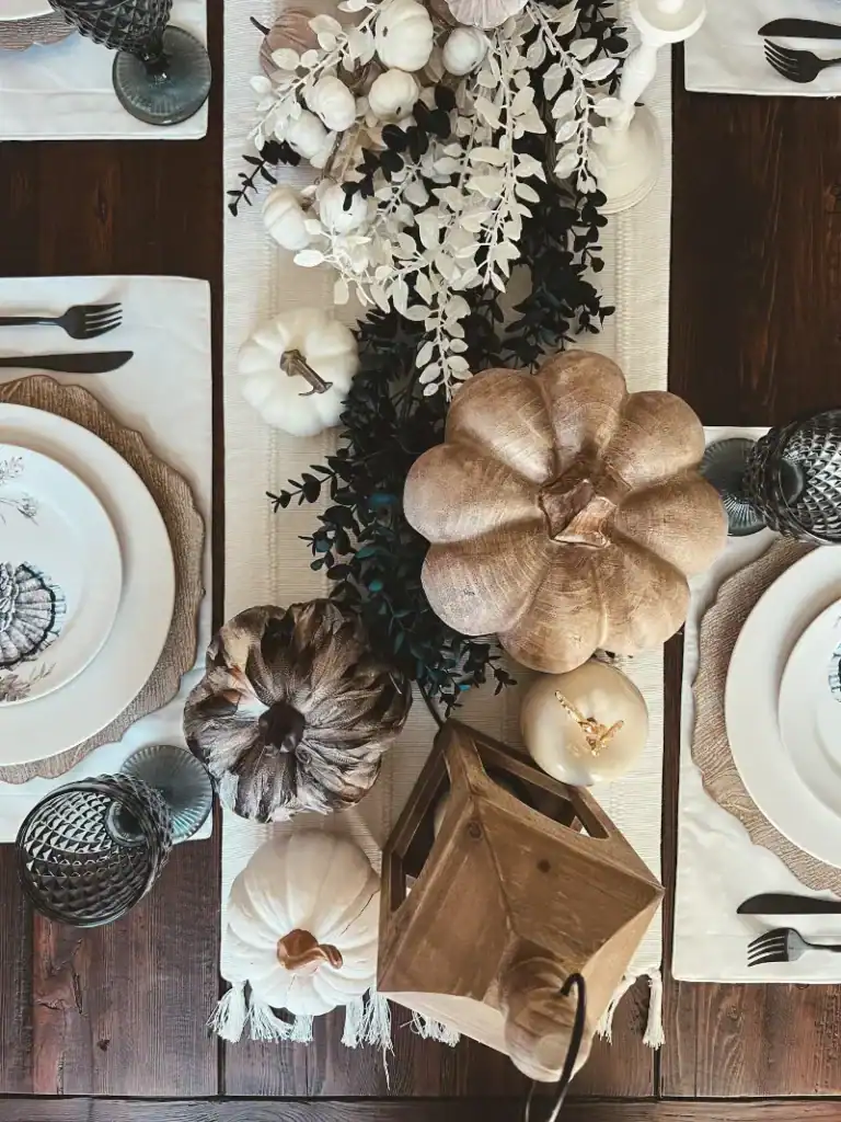 Top view of a thanksgiving tablescape decorated with wood, blue and white accents
