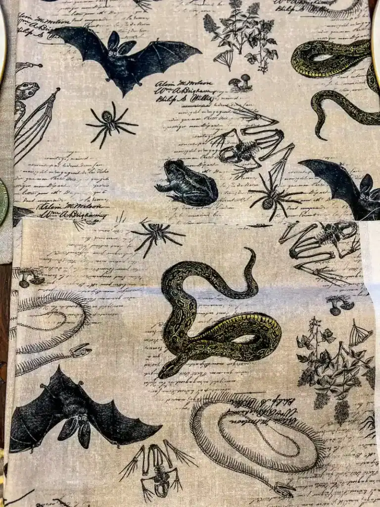 Ivory fabric with Halloween themed frogs, snakes, and bats
