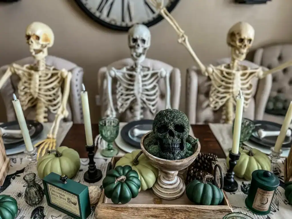 a green decor themed halloween tablescape with skeletons smiling and green pumpkins