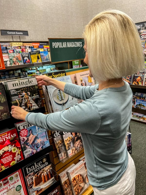 Woman grabbing Mingle Magazine at HobNob House bookstore.