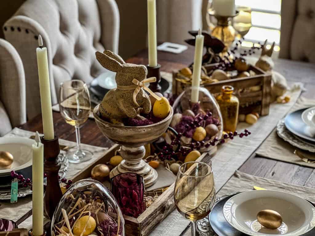 Easter tablescape with purple and yellow accents, candles, and festive decorations for spring celebr.