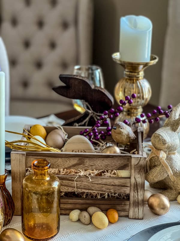 Easter tablescape featuring purple and yellow decorations, candles, and eggs for a festive spring dinner