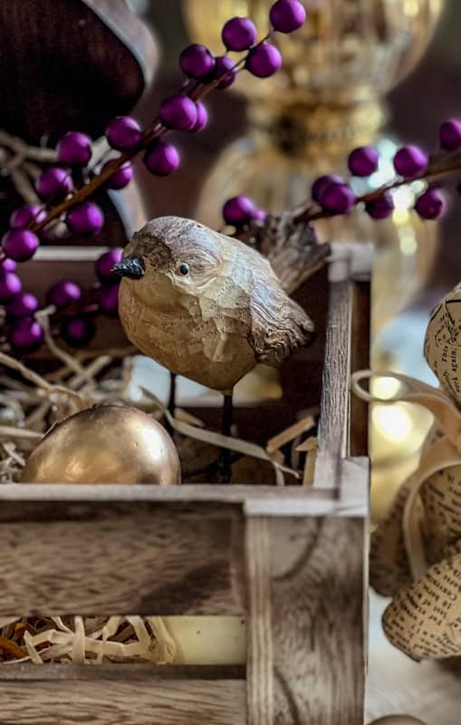 Easter tablescape with purple berries, yellow accents, a rustic bird and festive decorations for spring celebratio.